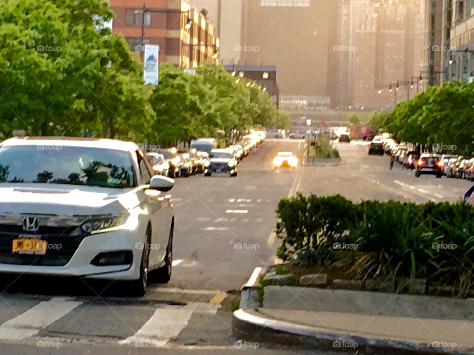 A sequential photograph of Vernon Jackson Ave in Long Island City, Queens, NY during the time of sunset and of upcoming twilight. The cars are beginning to put their headlights on. 2020. Hypnotic Productions