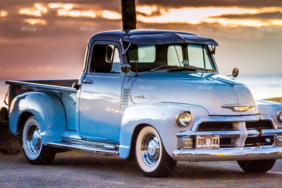 1954 Chevrolet pickup truck at the beach during sunset, North Shore Hawaii.  
