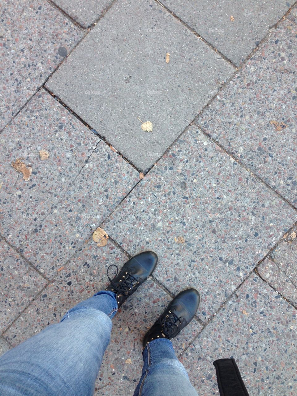 Dr. Martens on the pavement. Leaves all around...