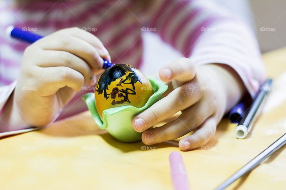 kid painting easter egg