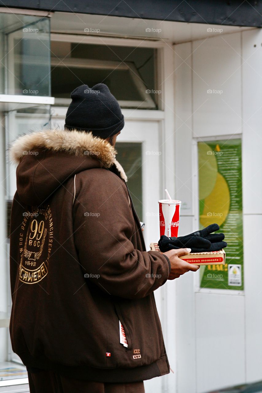 A person with pizza and soda