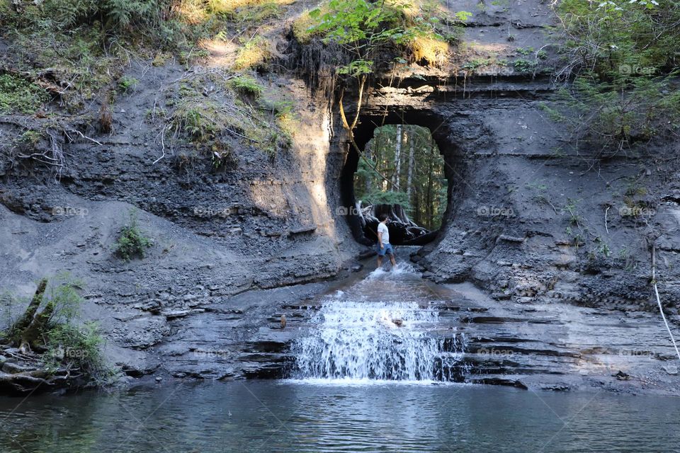 man in front of hole in the wall