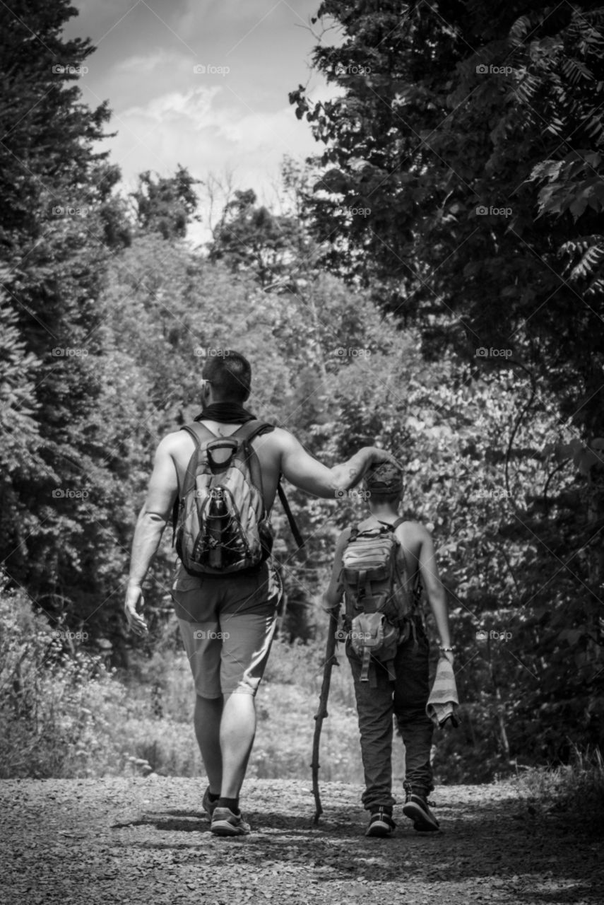 Man and Son Hiking on a Trail