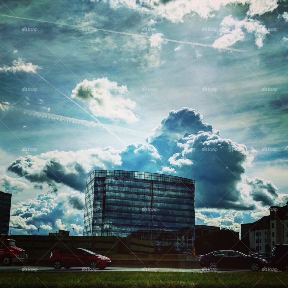 Clouds are just fluffy hats for buildings. This photo as taken in Sandy Springs, GA.