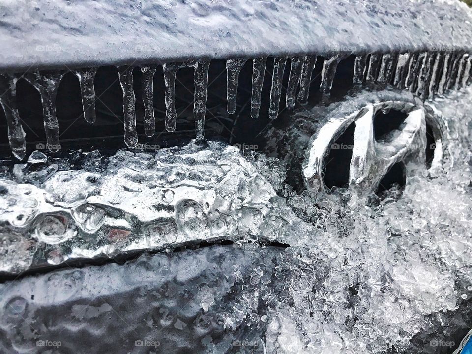 Line of icicles on the front of a car 
