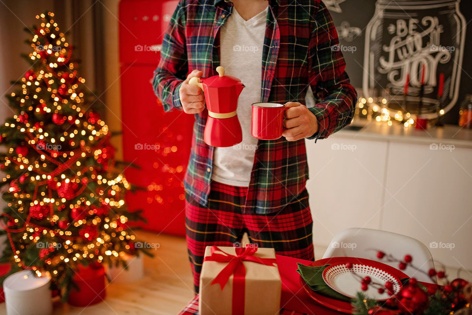 man sets a beautiful decorated winter table for a festive dinner.  Merry Christmas and Happy New Year.