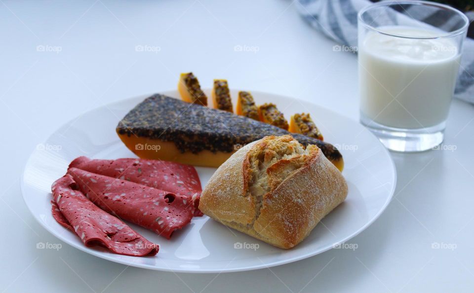 Vegetarian breakfast.  Vegan  salami,  cheese with pepper and pastry on a white plate