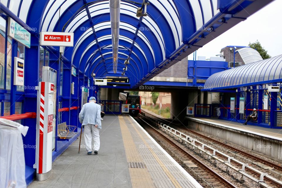 Old, stylish man leaving the DLR one fine Sunday morning