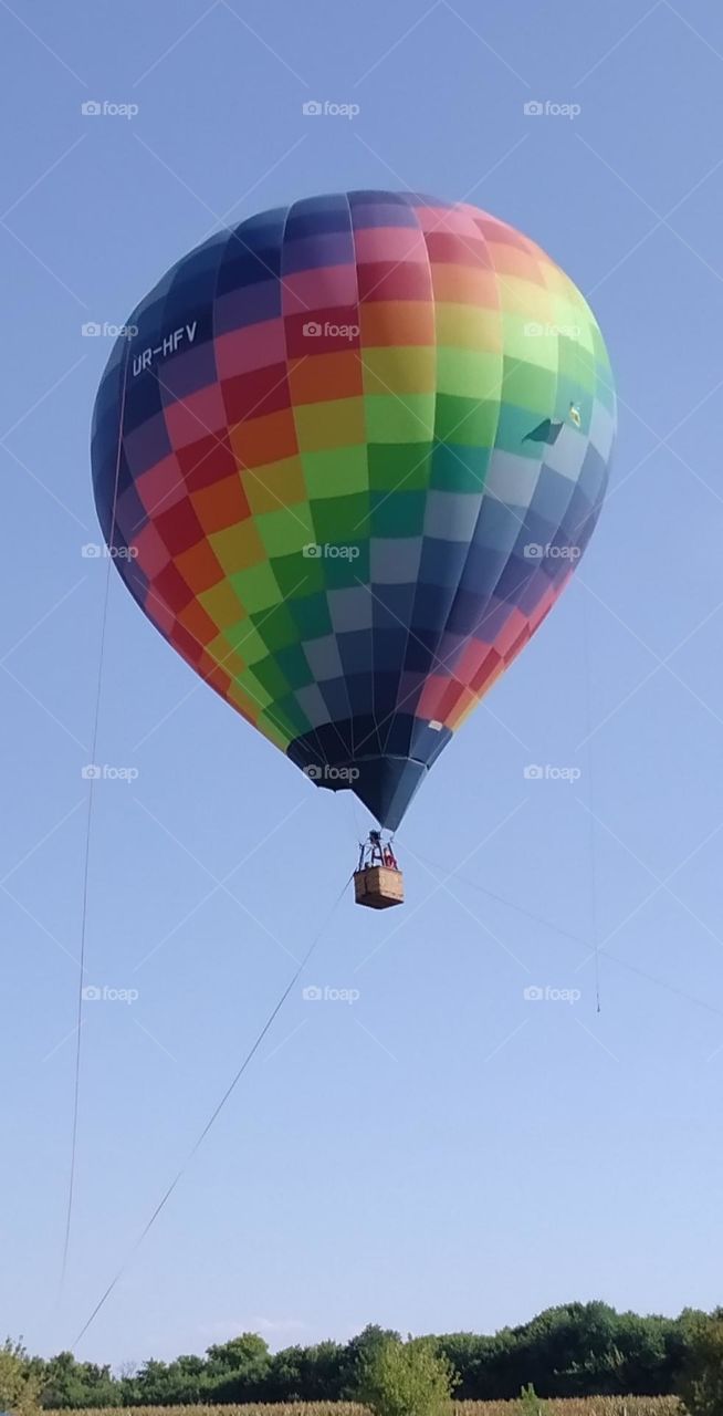 A balloon in the blue sky.