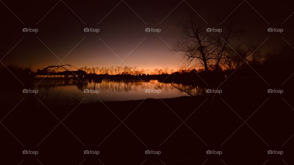 Silhouette Evening. Peaceful Surroundings. Beautiful Colors. Clear Atmosphere. Major Reflections on Lake Waters. Backlit Light, Dark, Night. 