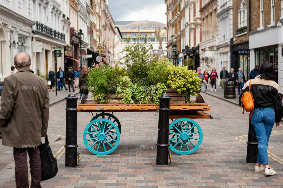 Cart full of flowers on display in old flower and vegetable market place. Covent Garden Market. London. UK