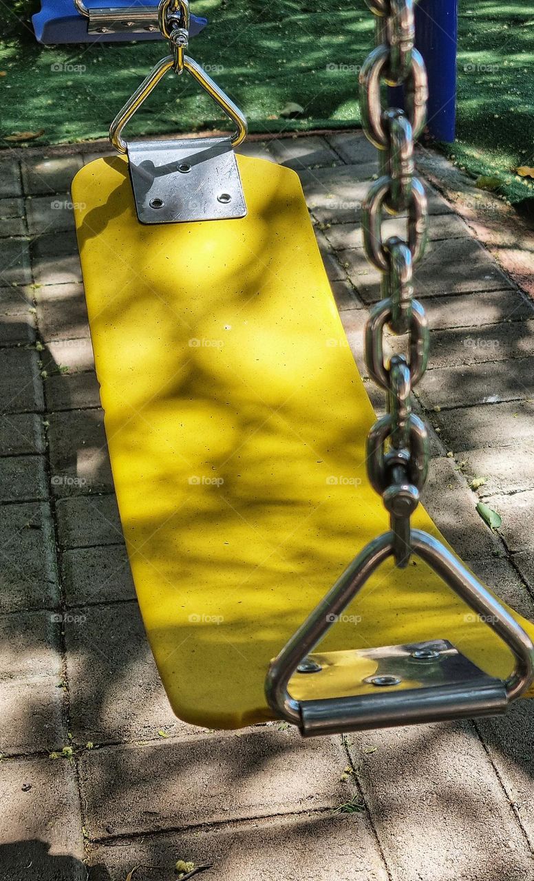 playground swing in yellow