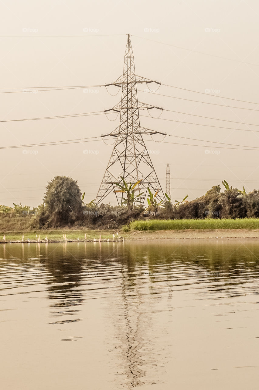 High voltage post of Electric Transmission tower (electricity pylon, steel lattice) and Power transmission line (overhead power line), industrial background