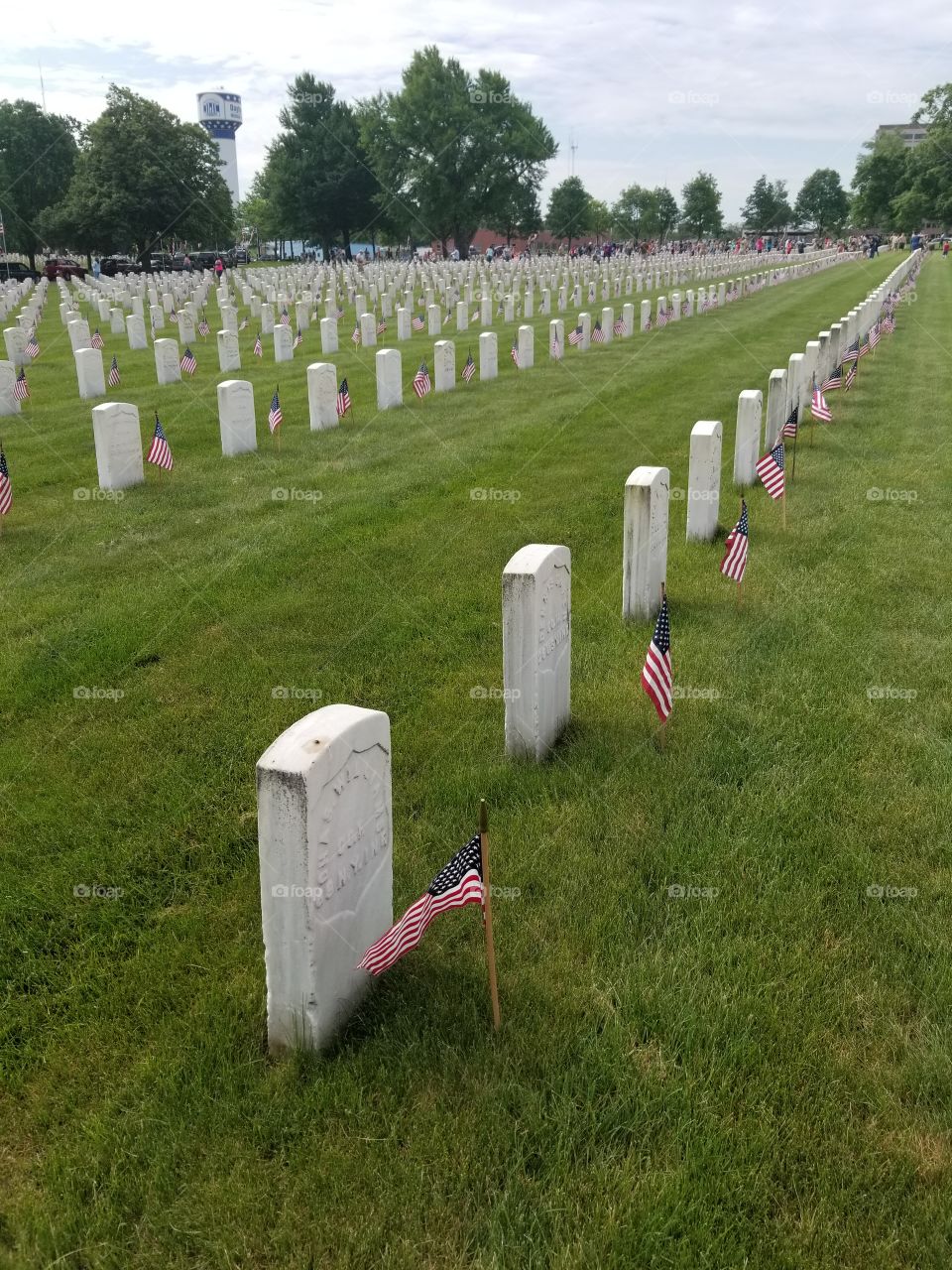 veteran memorial headstones with flags on memorial day