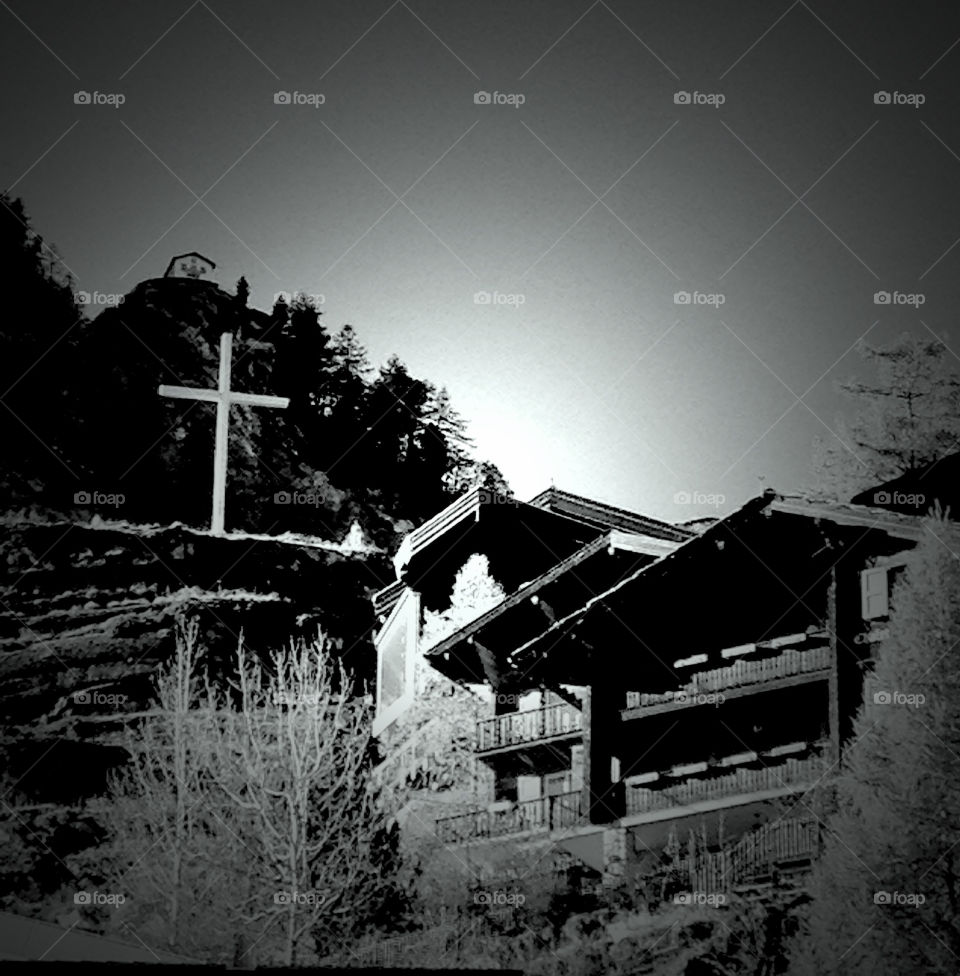 effect on the mountain with a house above  the cross by swisstraveler