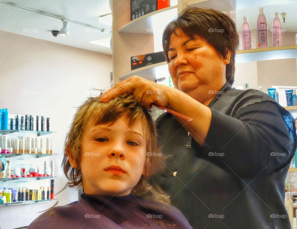 Young boy getting a haircut