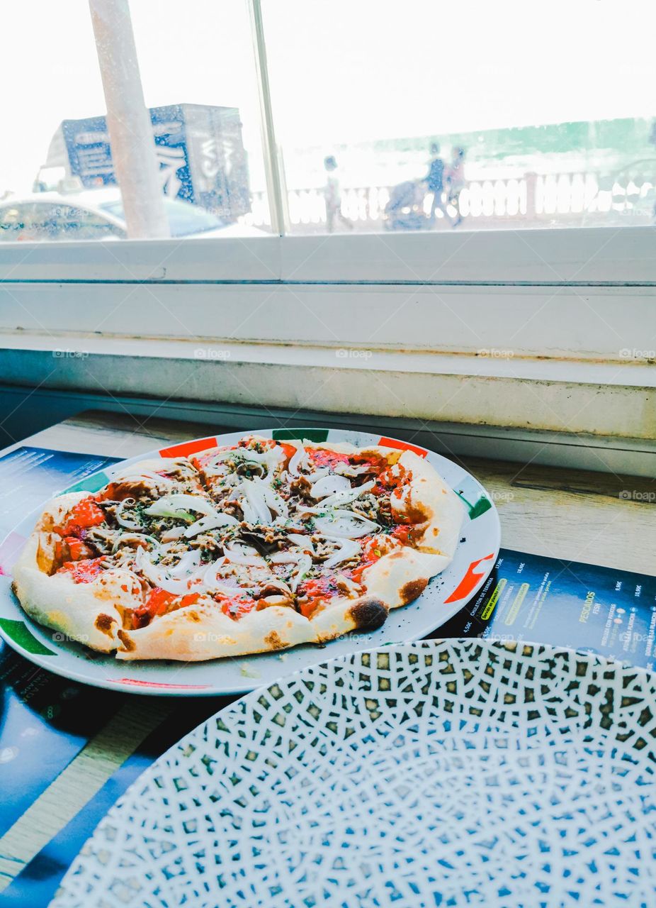 Tuna Pizza in a restaurant by the seafront