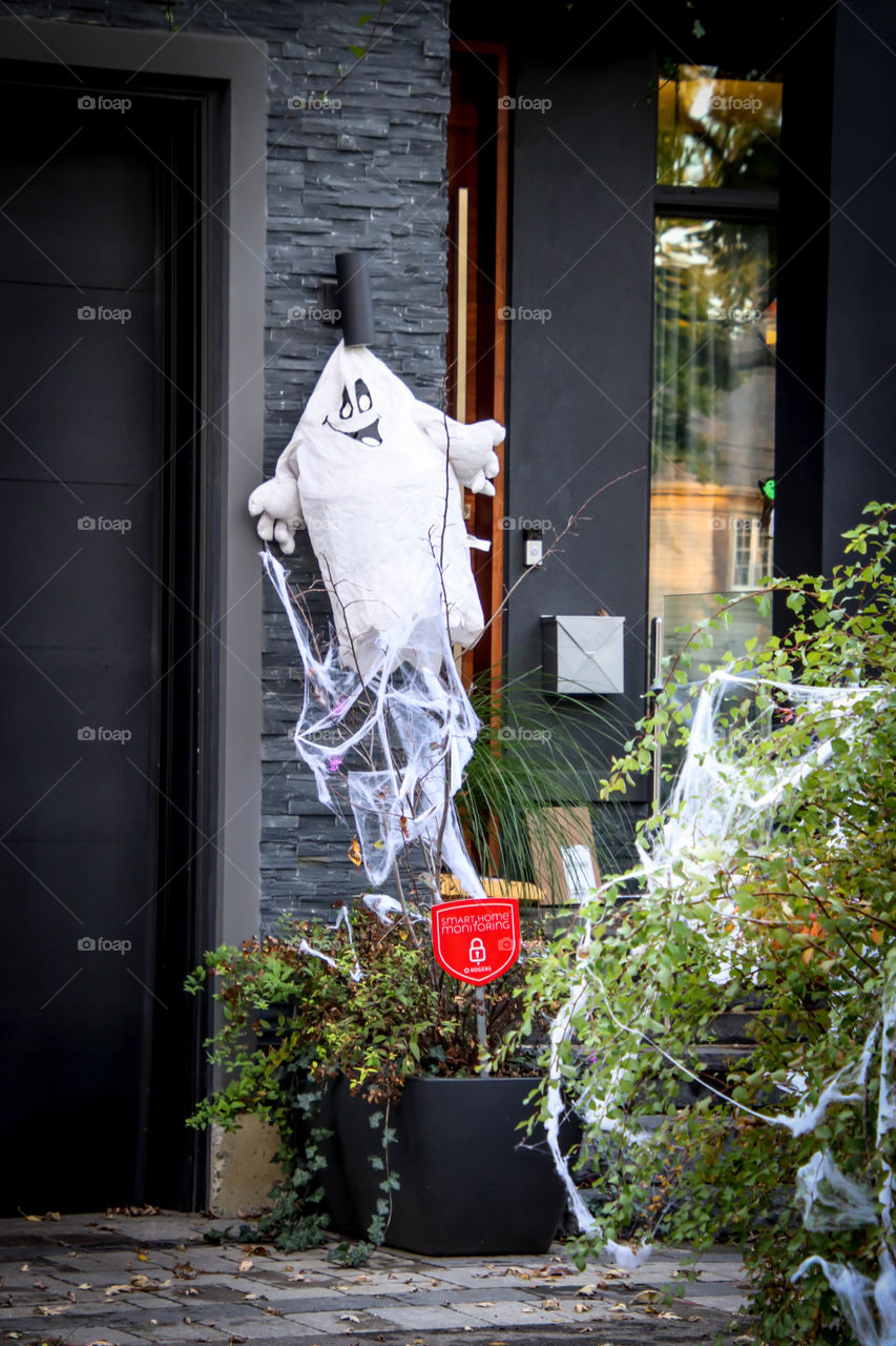 Cute ghost at the entrance to the house, Halloween decoration