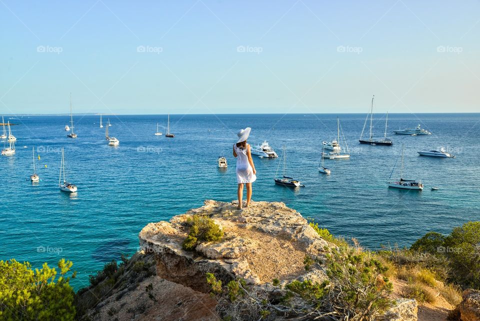 Rear view of a women standing on rock