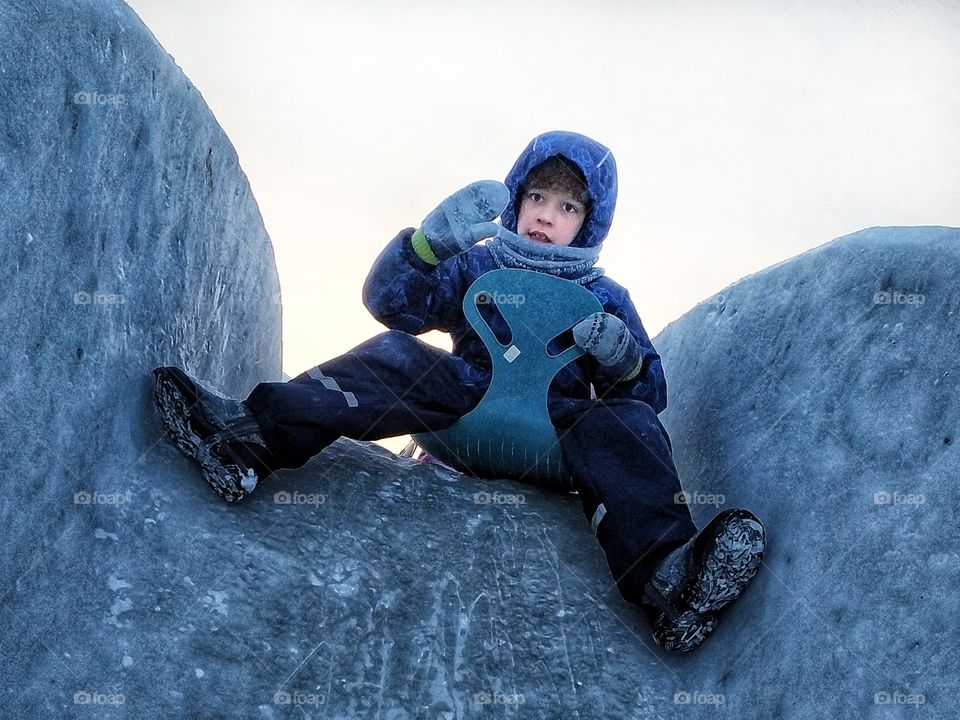 Baby rolling down the ice slide
