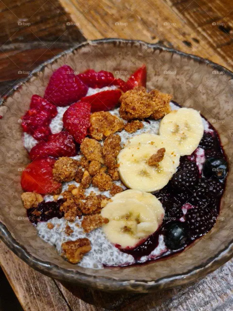 Plant based. Oatmeal with banana, raspberry, blackberry and dried fruits. Healthy lifestyle.