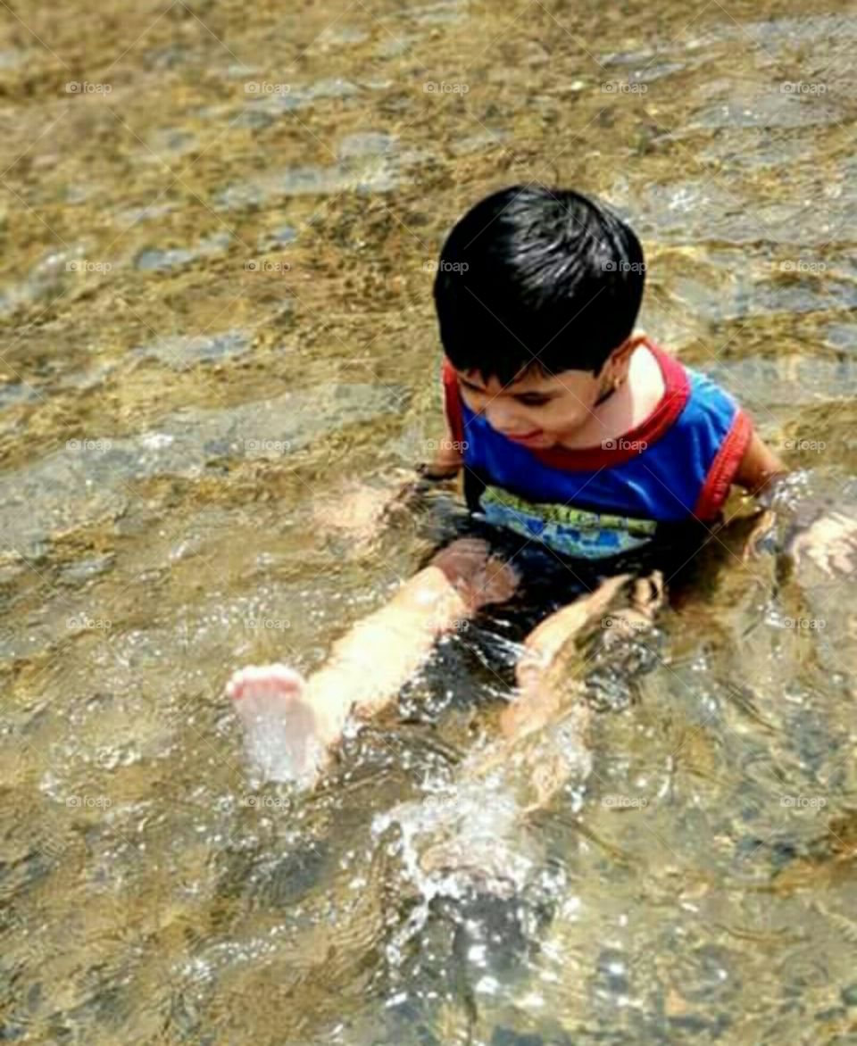 Happy child playing in the water