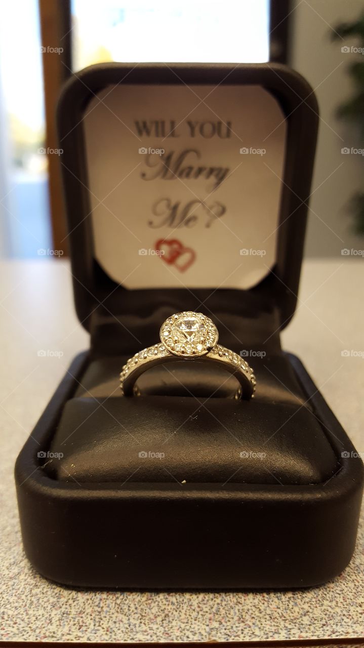 A proposal of marriage comes in the form of a diamond engagement ring and a question to ponder over.