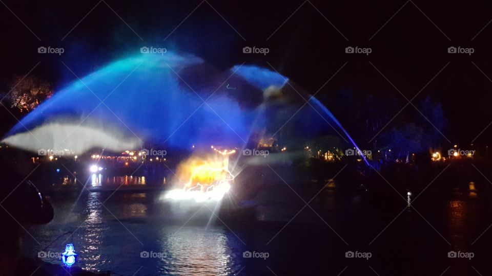 A mist of water illuminates the night sky over Discovery River during Rivers of Light at Animal Kingdom at the Walt Disney World Resort in Orlando, Florida.