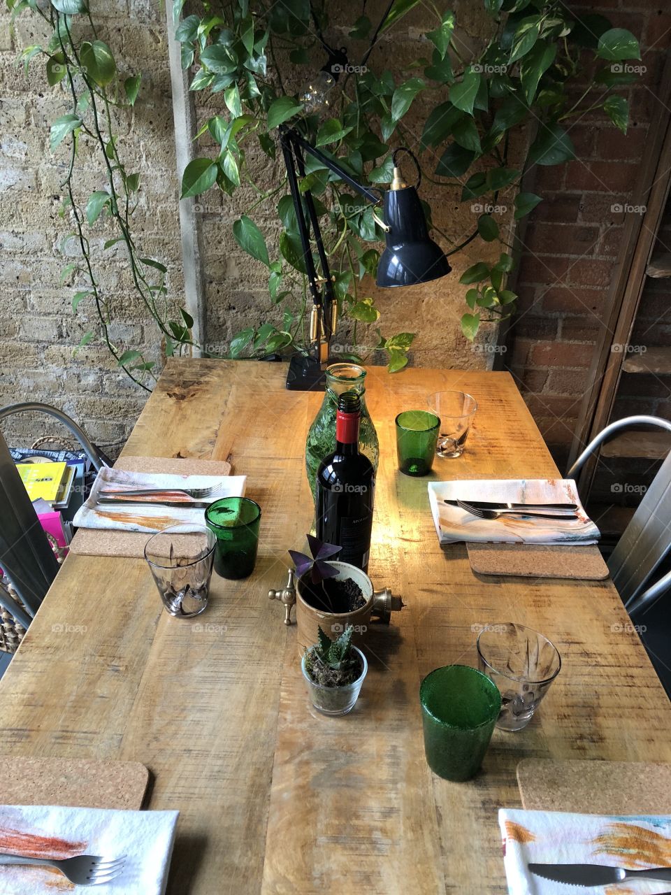 Rustic wooden table with place settings for Sunday lunch in cost warehouse interior