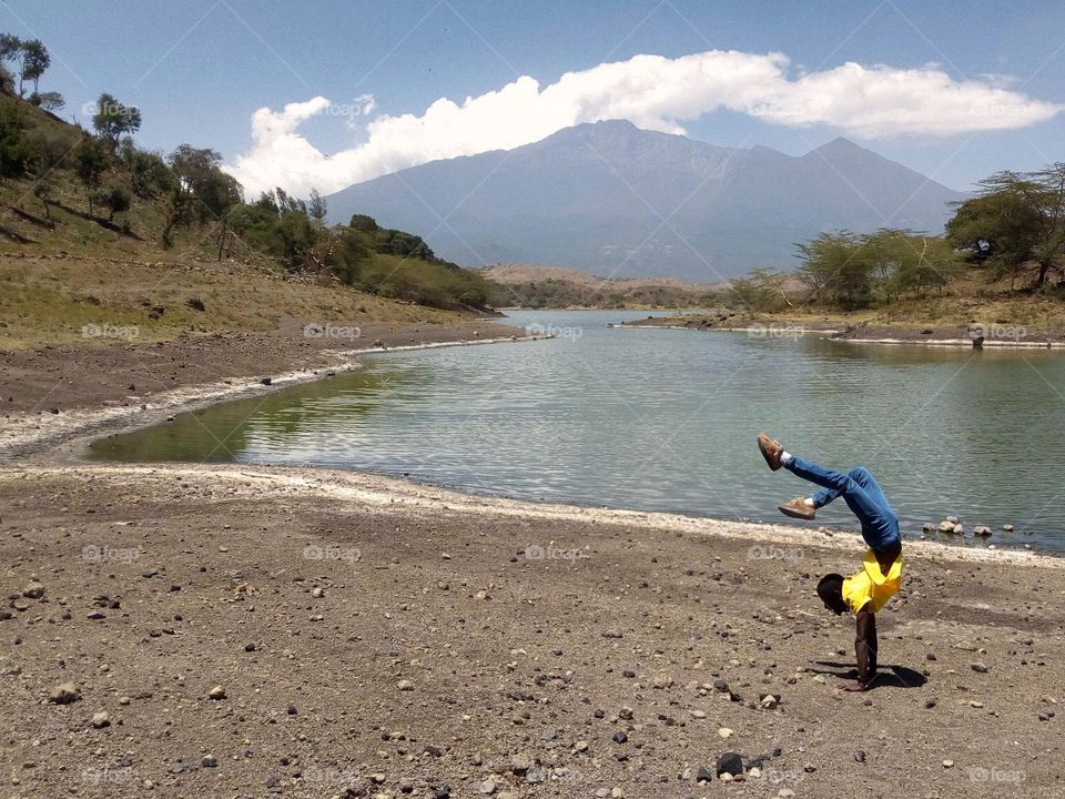 Handstand yoga pose at lake Momela in Arusha-Tanzania