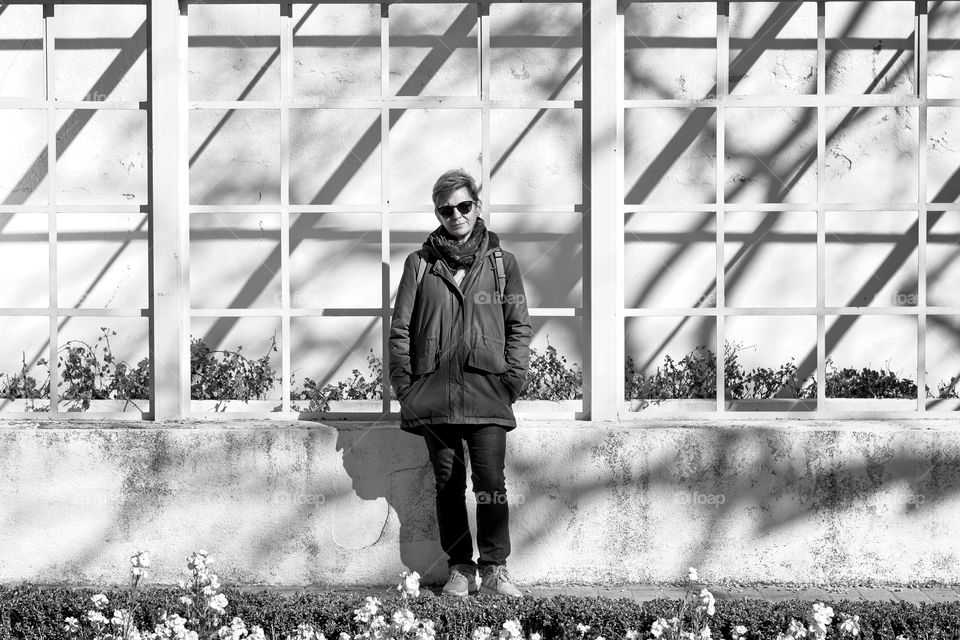 Woman standing in front of a background full of shadows