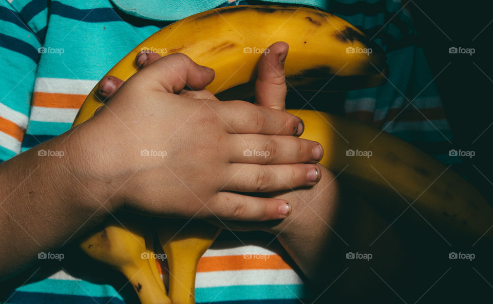 Bananas in child's hands