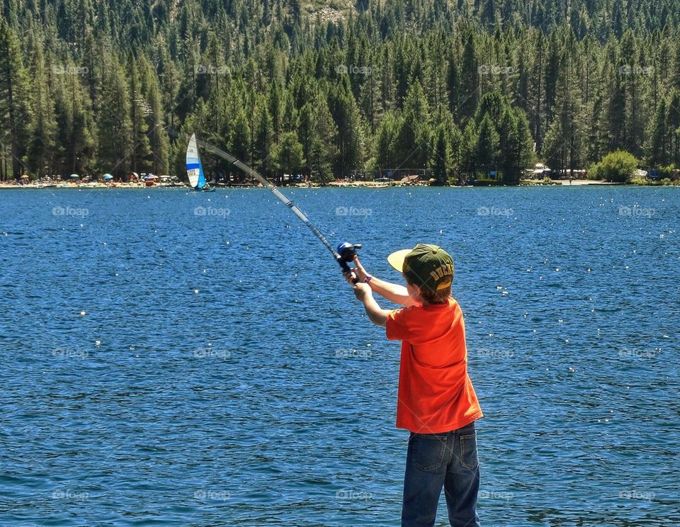 Young Boy Casting A Fishing Line

