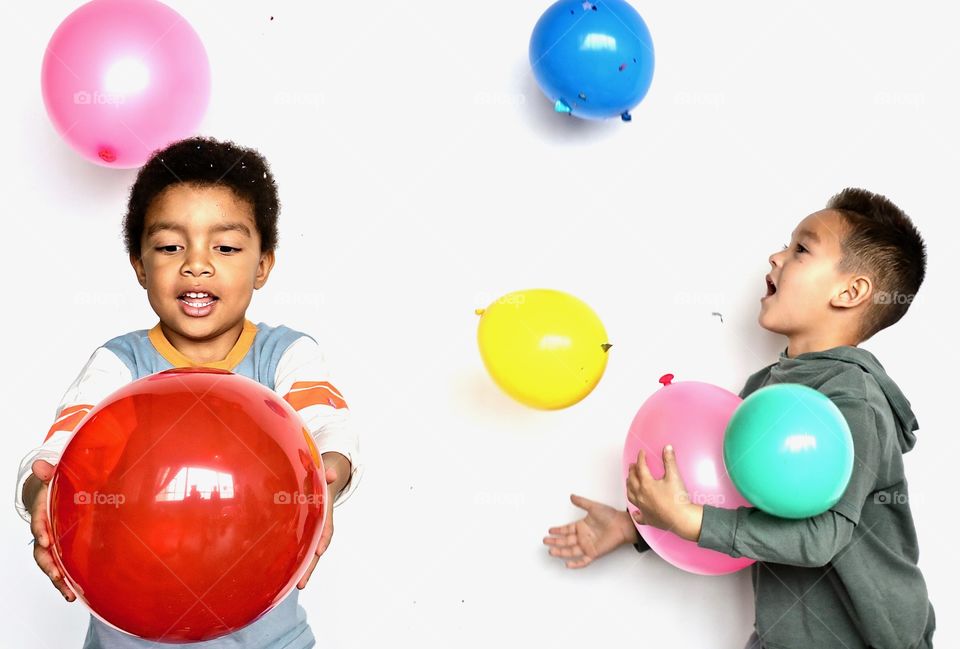 Boys playing with balloons