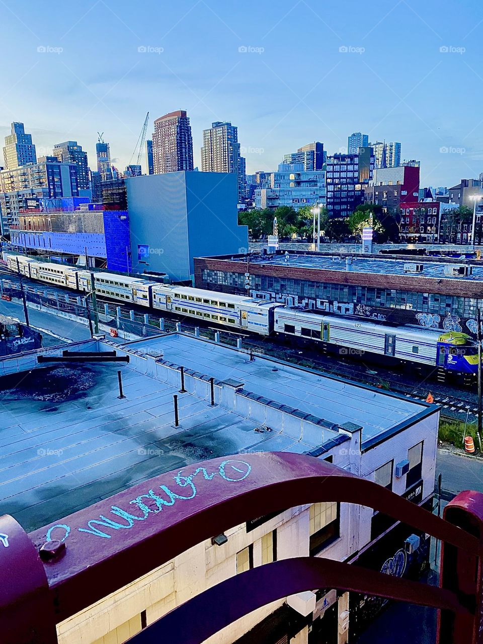 This is the “Long Island Railroad” approaching us on the tracks seem from the top of the staircase of the “Pulaski Bridge” on the LIC, Queens side on a warm Indian summer evening in early October 2023. Hypnotic Productions
