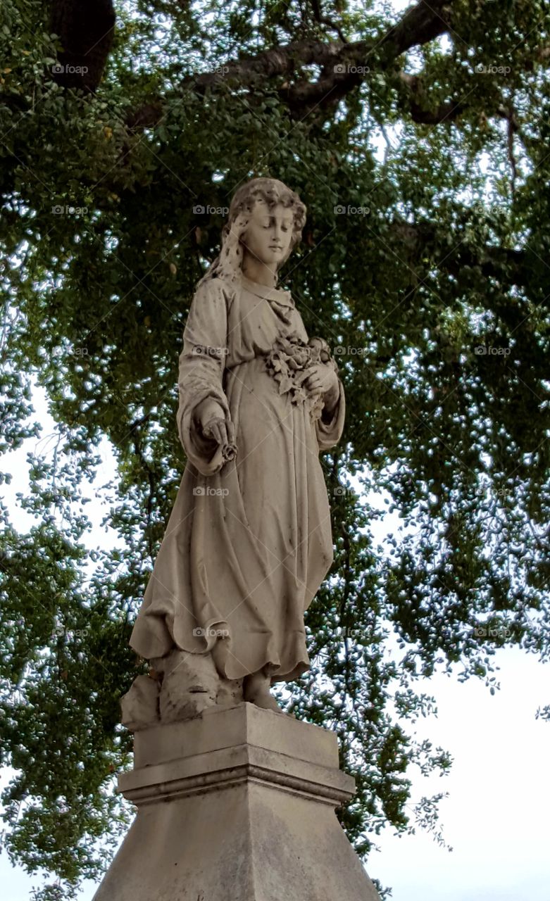 this statue was about 10 feet tall on top of an obelisk like tomb stone. in the Santa Clara Mission Cemetery's oldest section.