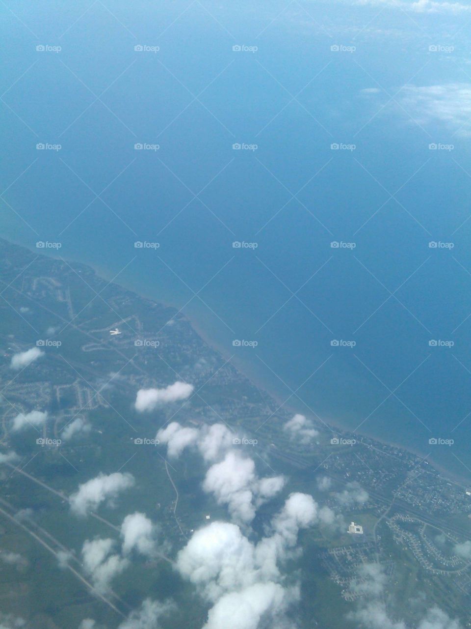 Airplane window view of land & lake