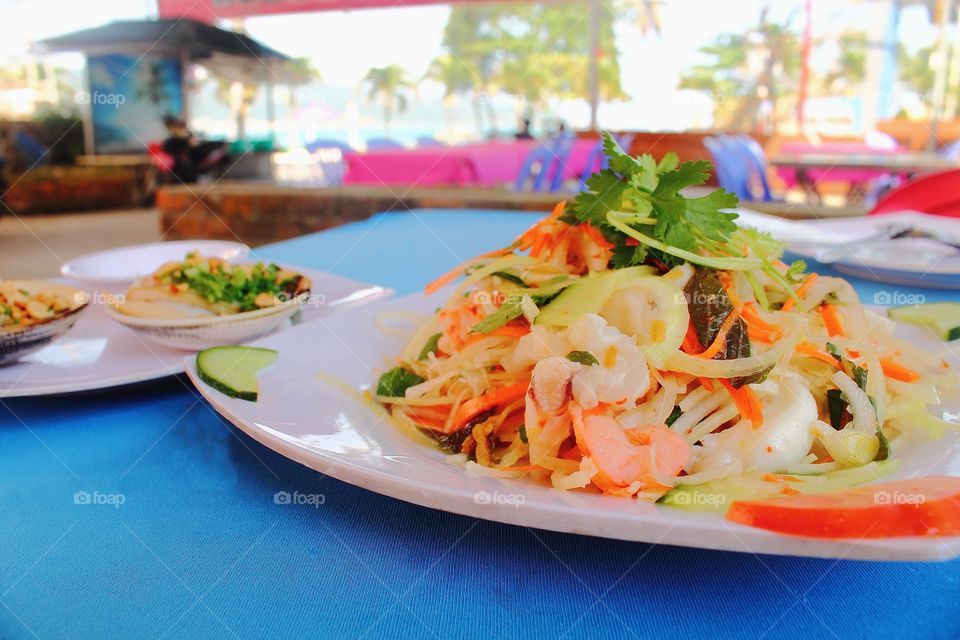 Fresh salad with seafood, tomatoes, celery and basil. Salad with squid, octopus, shrimp, mussel. Seafood concept. Top view.