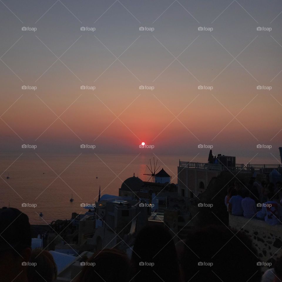 The most famous and romantic sunset in the world in Ia, Santorini. Every visitor in Santorini wait for this moment to admire the colorful sky and the calm sea, as the sun goes down.