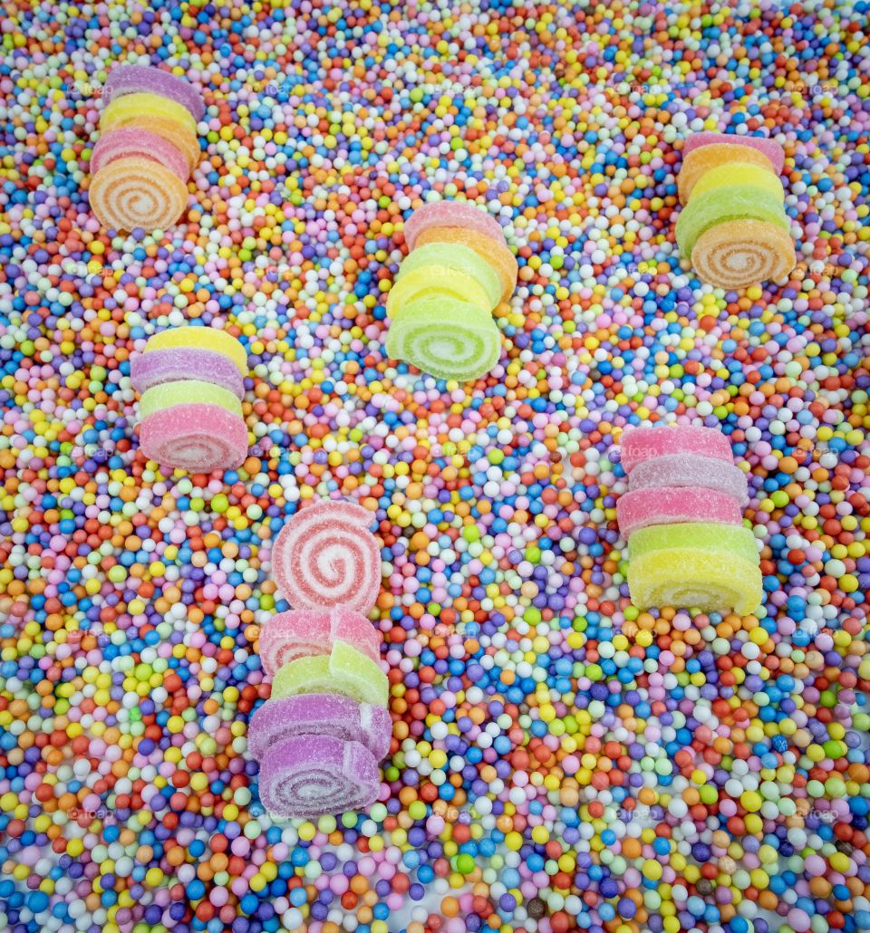 Sugar roll in the colorful field , Confectionery,Sweets,Candy,Lollies,Treats in the colorful background