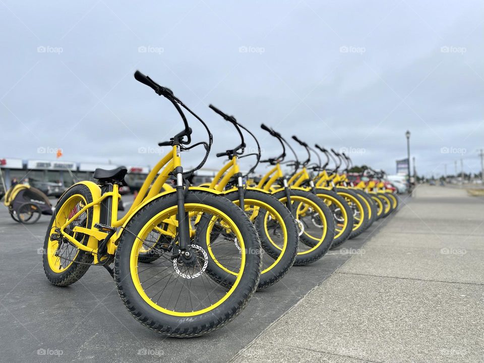 Many yellow bicycles at the parking 