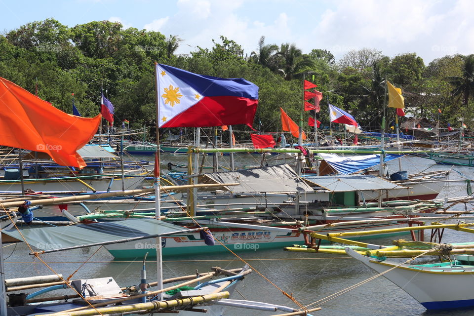 Philippines.  flag. boats. fishing  village.