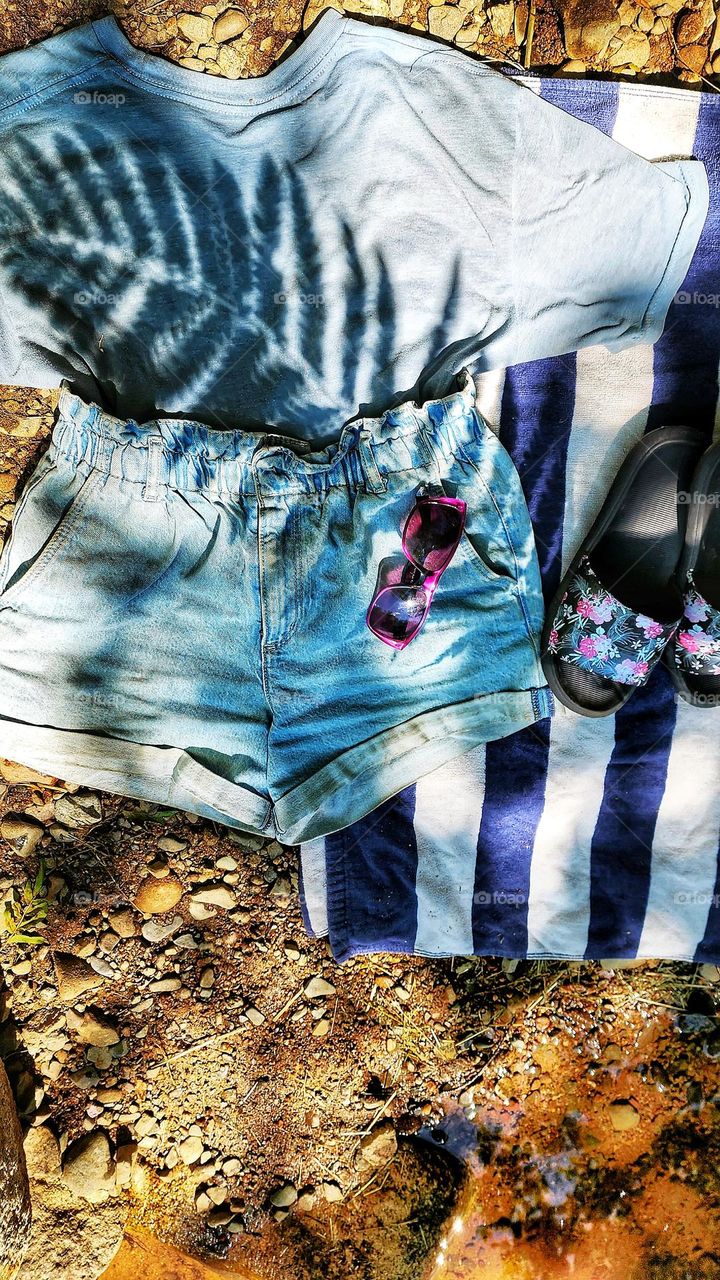 Summer outfit laid out by the river