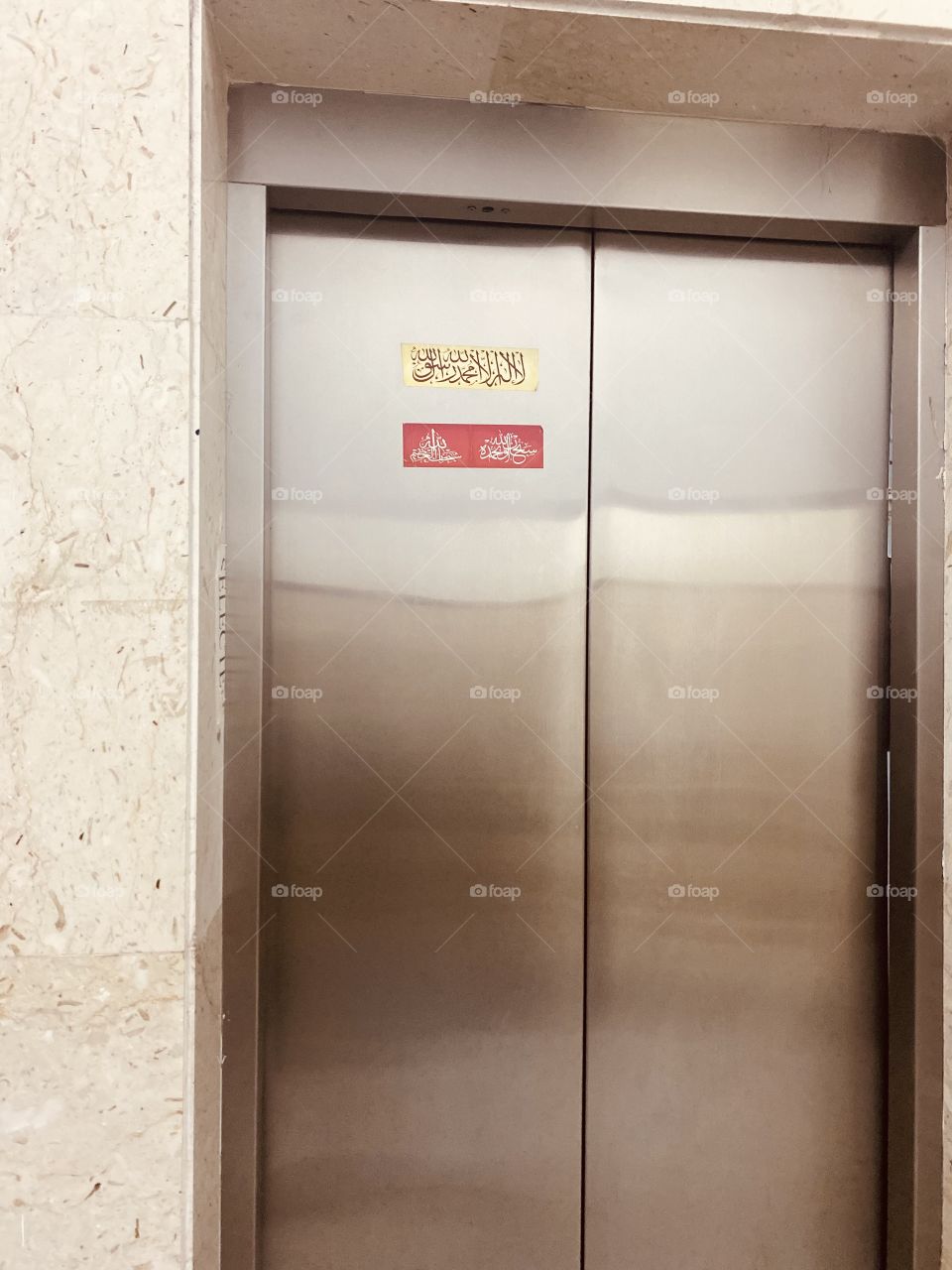 Remember of God at the elevator door to remind visitors to the mosque to remember and earn reward 