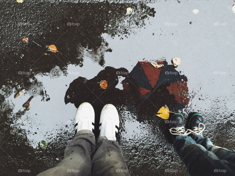 Father son puddle reflection. Father and son reflection in rain puddle water