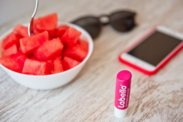 Eating watermelon and Labello stick on the table 