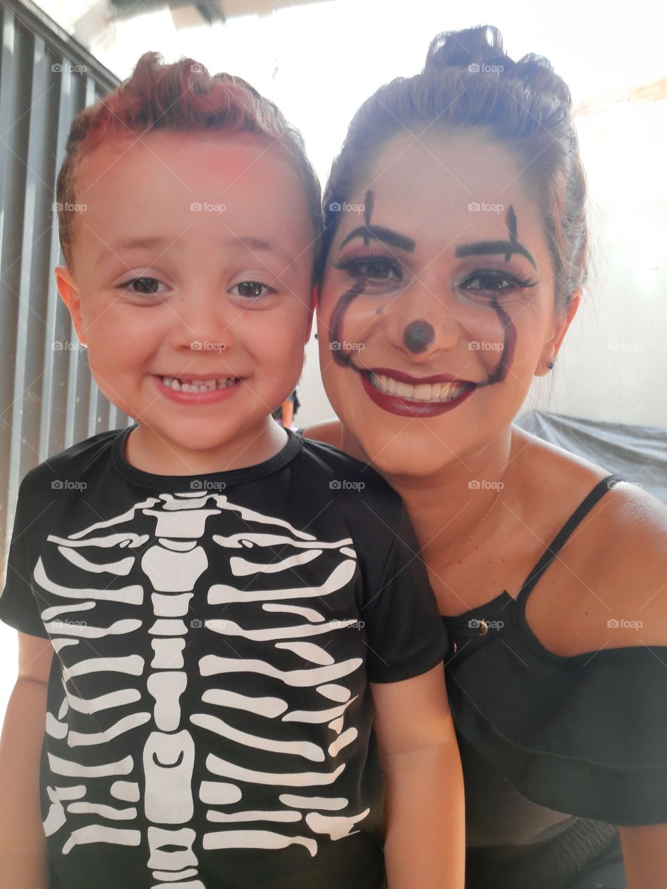 cute boy and mother dressed in halloween theme
