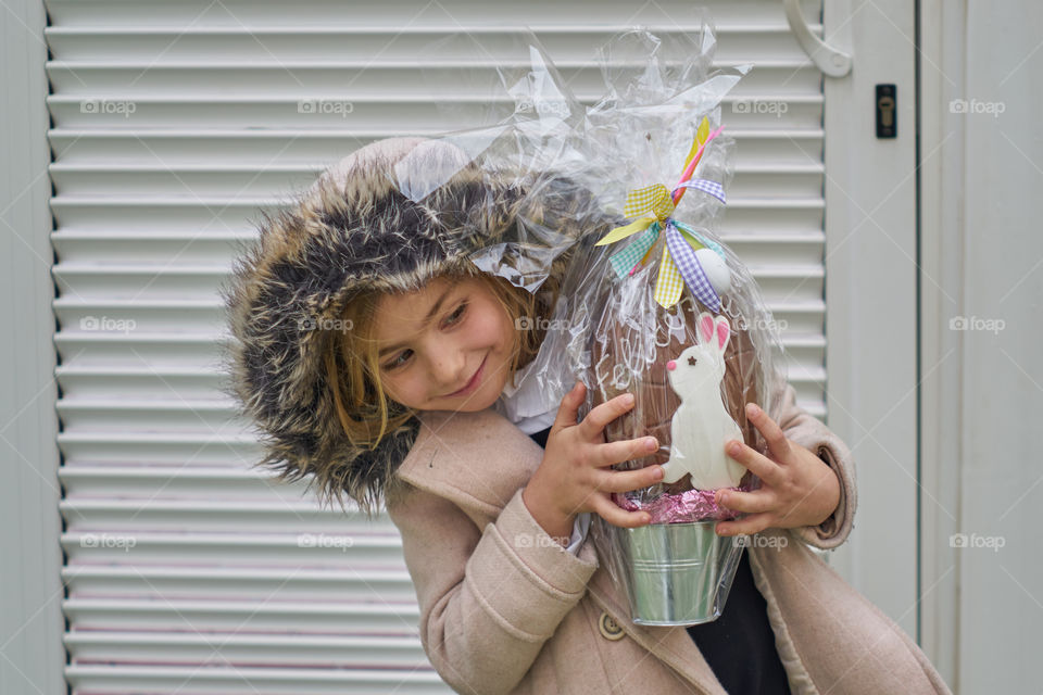 Smiling girl's hand holding gift