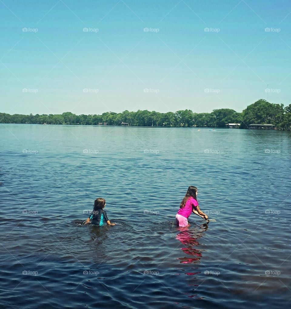 Children swimming in lake