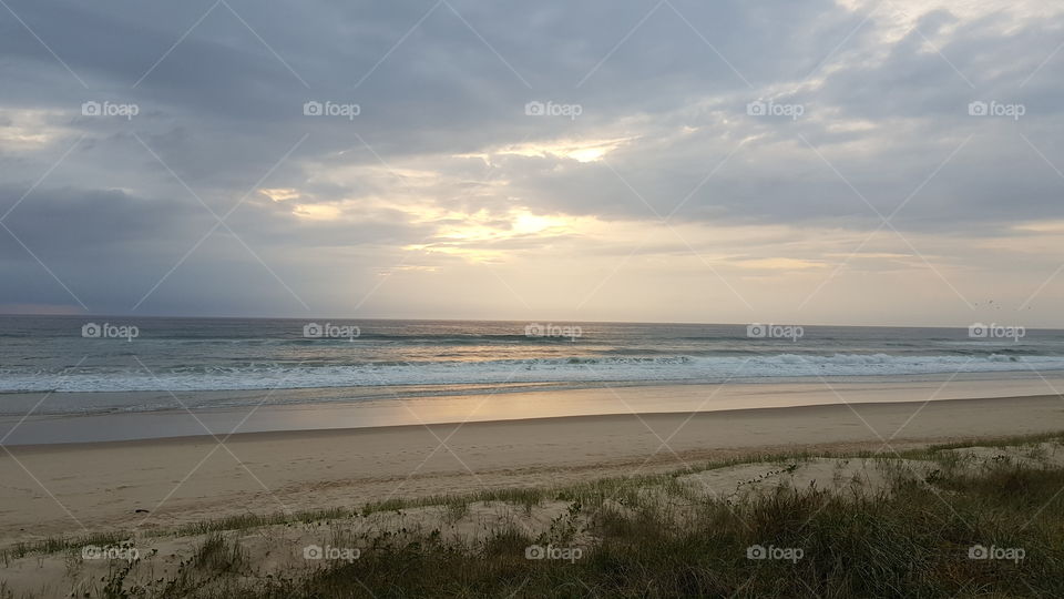 Storm sky over ocean at dawn